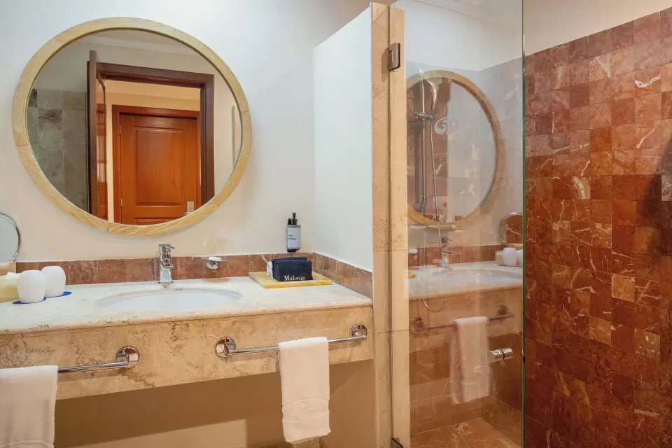 Deluxe Room bathroom sink and shower at Grand Palladium Colonial Resort & Spa