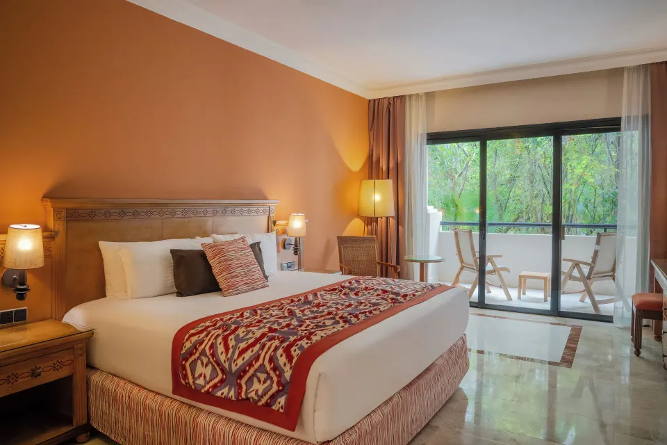 Deluxe Room king bed and balcony at Grand Palladium Colonial Resort & Spa