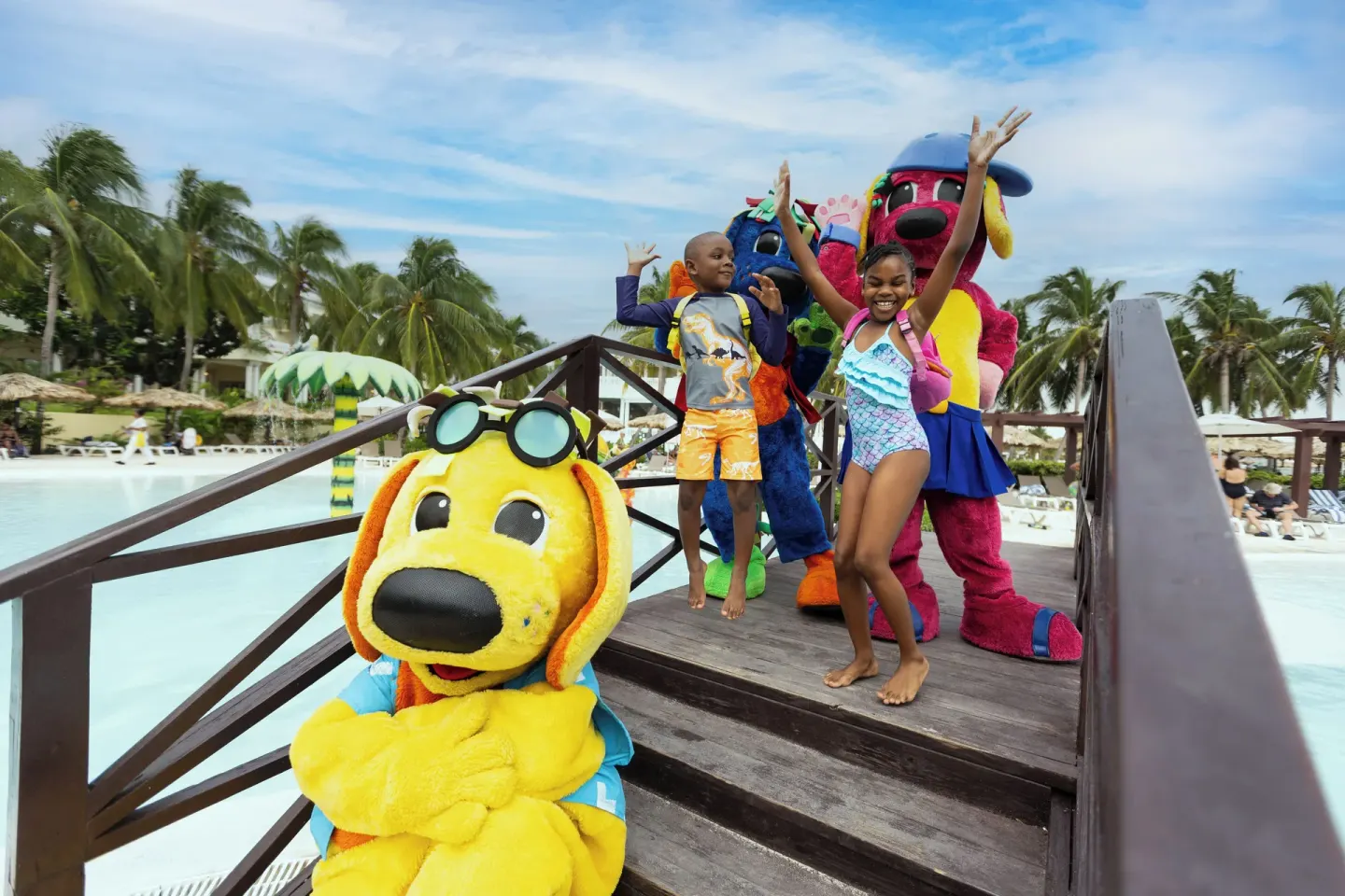 Children and costumed characters on a pool bridge at Grand Palladium Jamaica Resort & Spa.