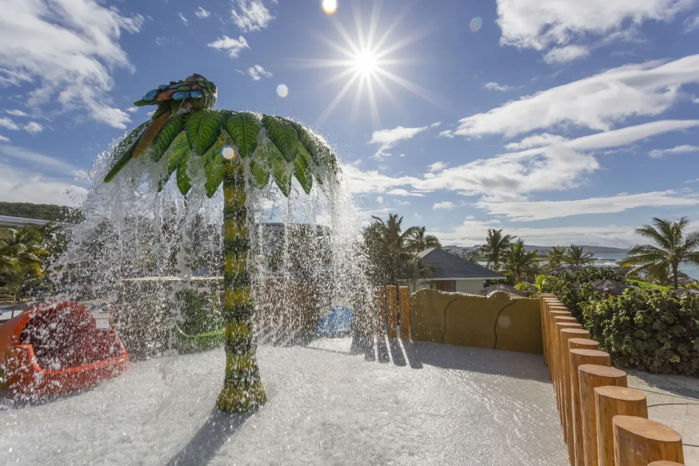 Children's splash feature with a palm-tree water bucket at Grand Palladium Jamaica Resort & Spa.