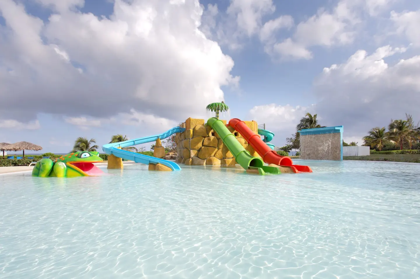 Colorful tube slides and frog figure in the splash pool at Grand Palladium Jamaica Resort & Spa.