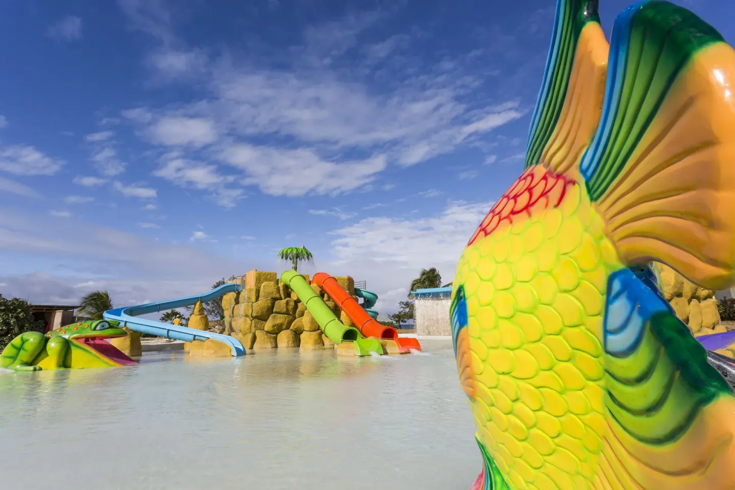 Fish sculpture and colorful pool slides at Grand Palladium Jamaica Resort & Spa.