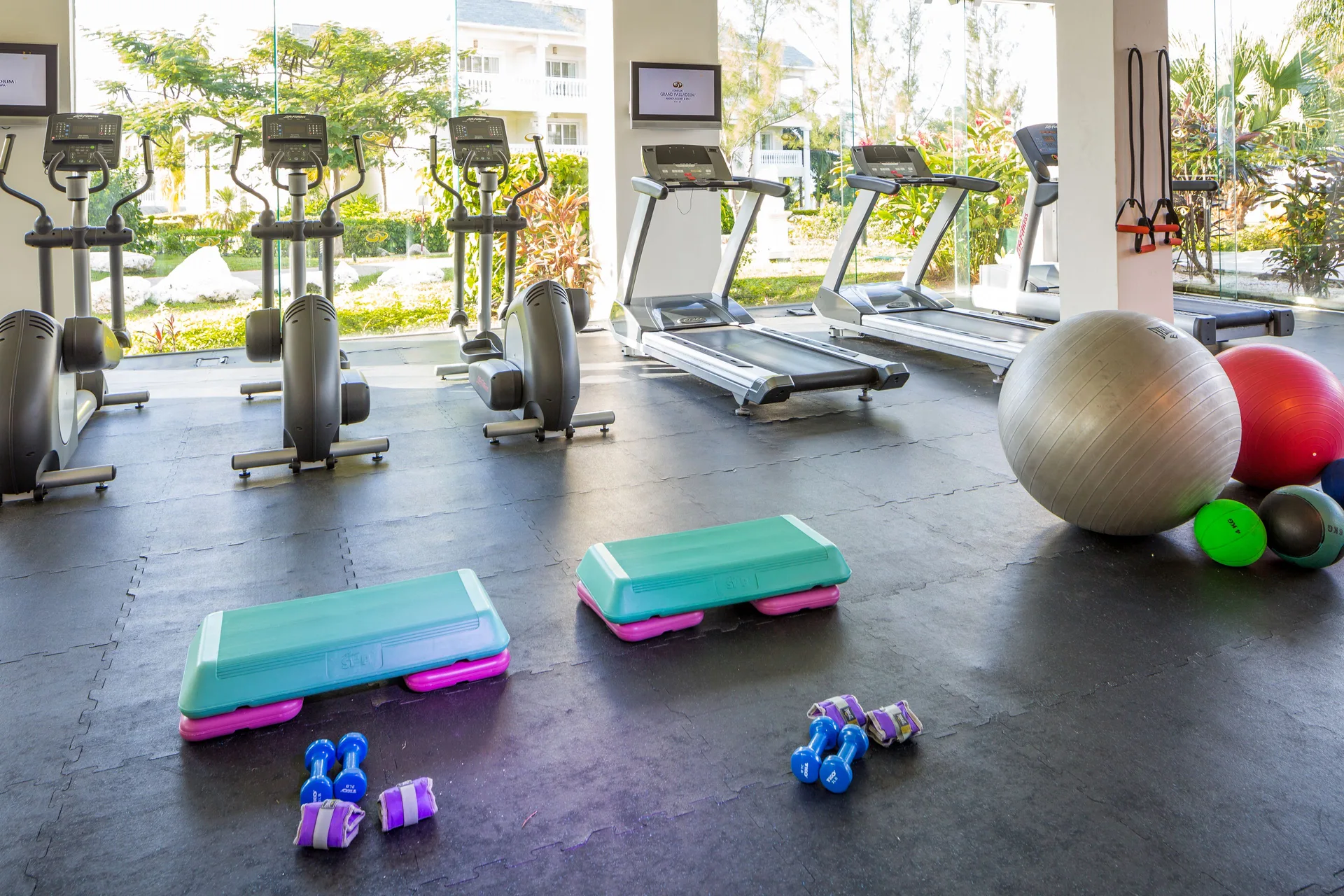 Fitness room with treadmills, ellipticals, weights, and exercise balls at Grand Palladium Jamaica Resort & Spa.