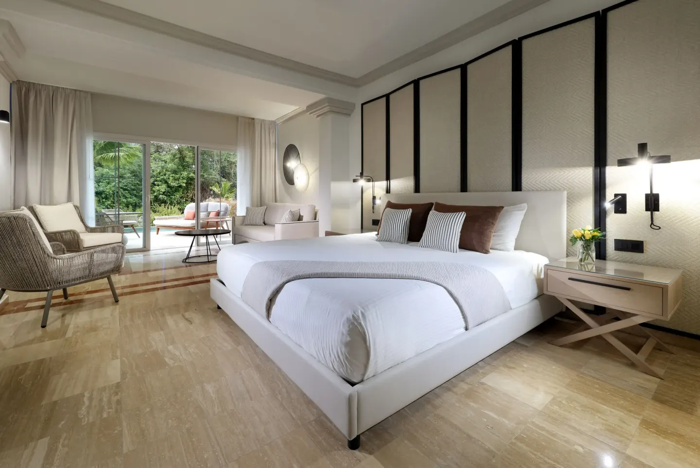 King bed guest room with lounge area at Grand Palladium Jamaica Resort & Spa.