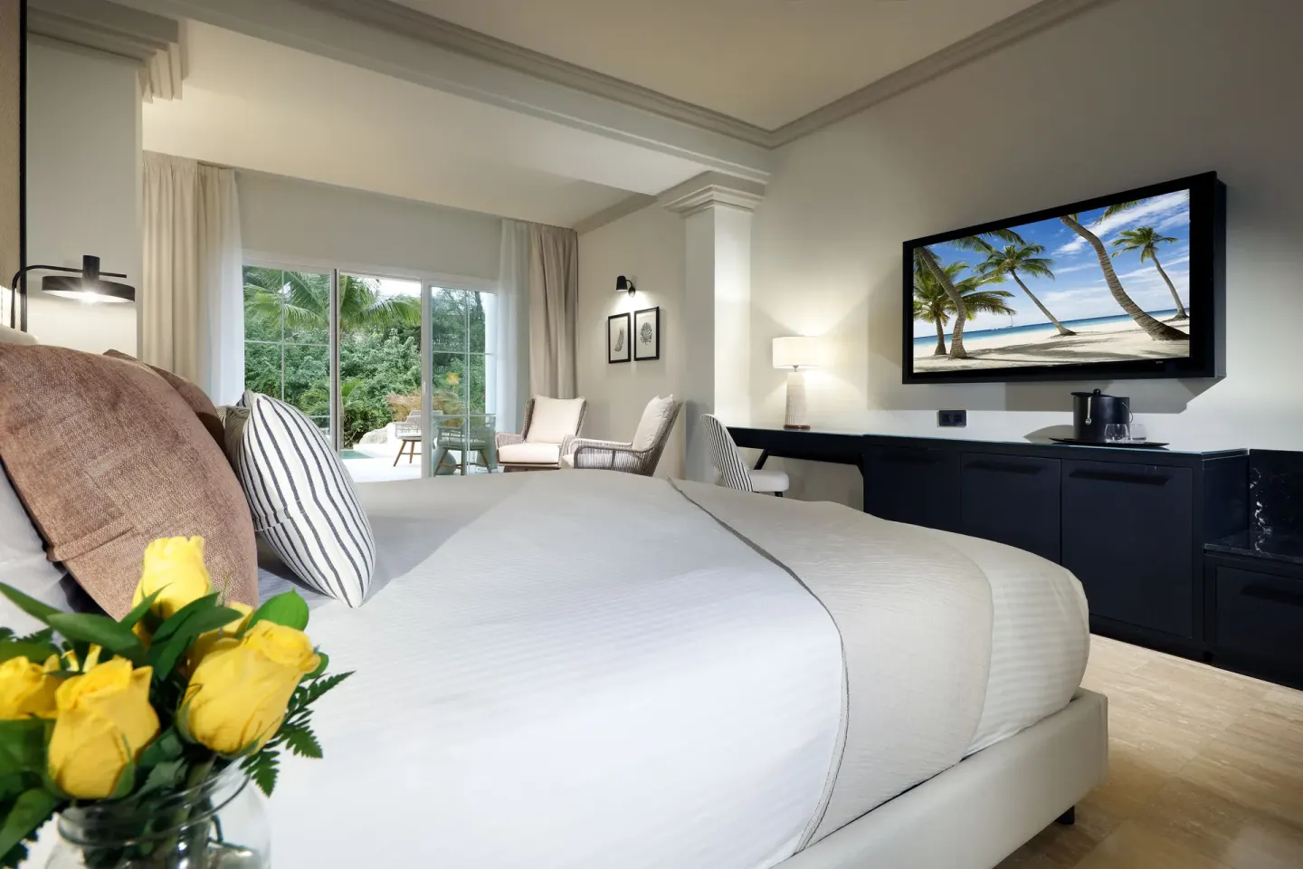 King bed guest room with media cabinet at Grand Palladium Jamaica Resort & Spa.