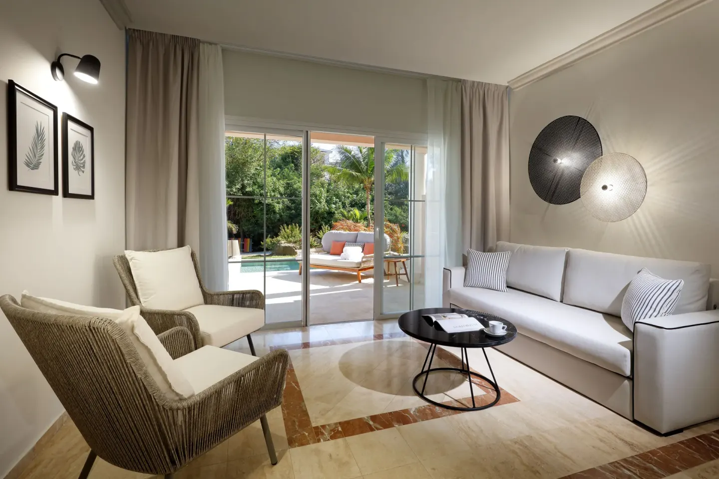 Guest room sitting area opening to a terrace at Grand Palladium Jamaica Resort & Spa.