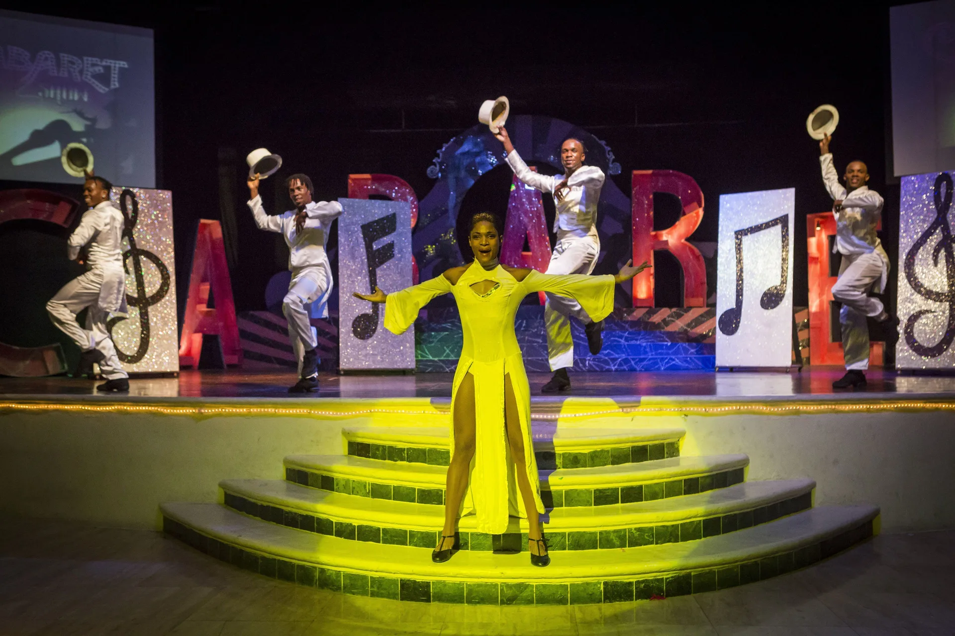 Stage dancers performing in colorful lighting at Grand Palladium Jamaica Resort & Spa.