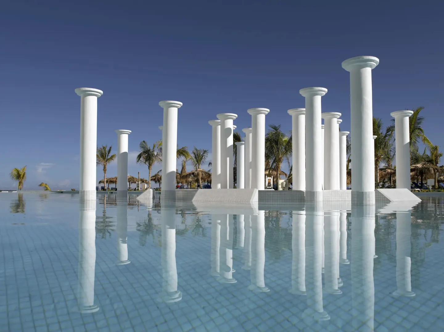 White columns reflected in a calm pool at Grand Palladium Jamaica Resort & Spa.