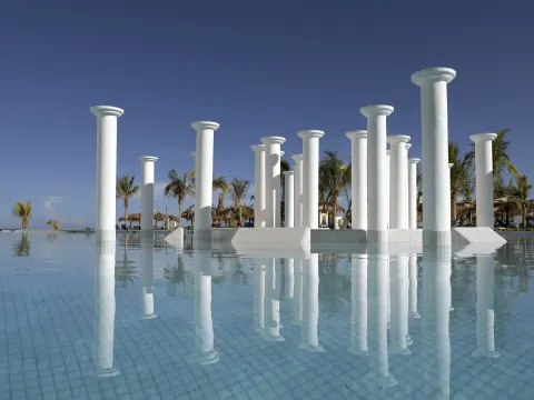 White columns reflected in a calm pool at Grand Palladium Jamaica Resort & Spa.