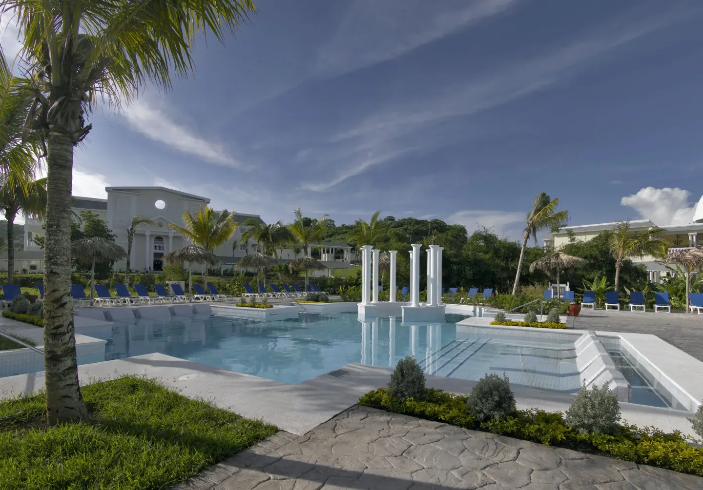 Quiet resort pool with columns and palms at Grand Palladium Jamaica Resort & Spa.