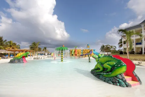 Splash pool with animal slides and resort building at Grand Palladium Jamaica Resort & Spa.