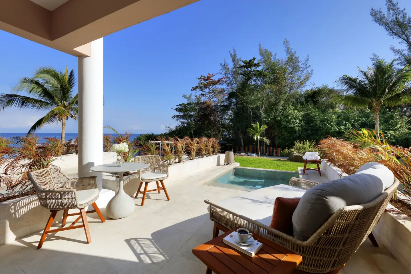 Terrace with plunge pool and ocean glimpse at Grand Palladium Jamaica Resort & Spa.