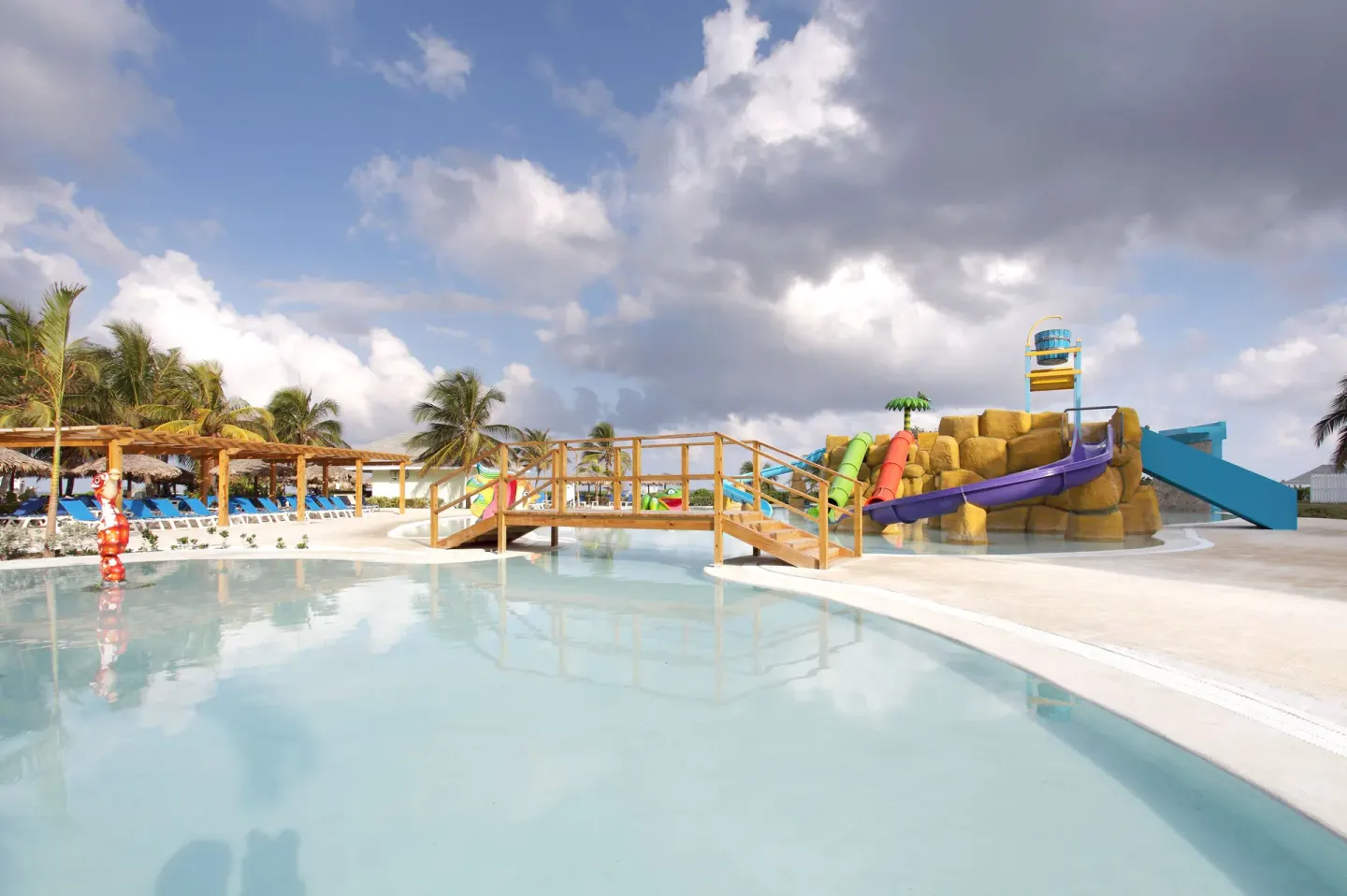 Water play area with a bridge and colorful slides at Grand Palladium Jamaica Resort & Spa.