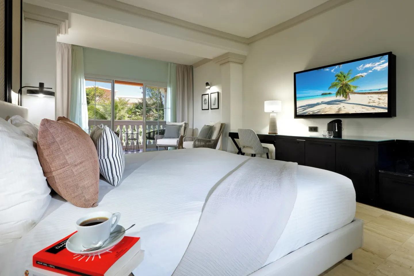 Junior Suite Ocean View king bed and balcony seating at Grand Palladium Jamaica Resort & Spa.