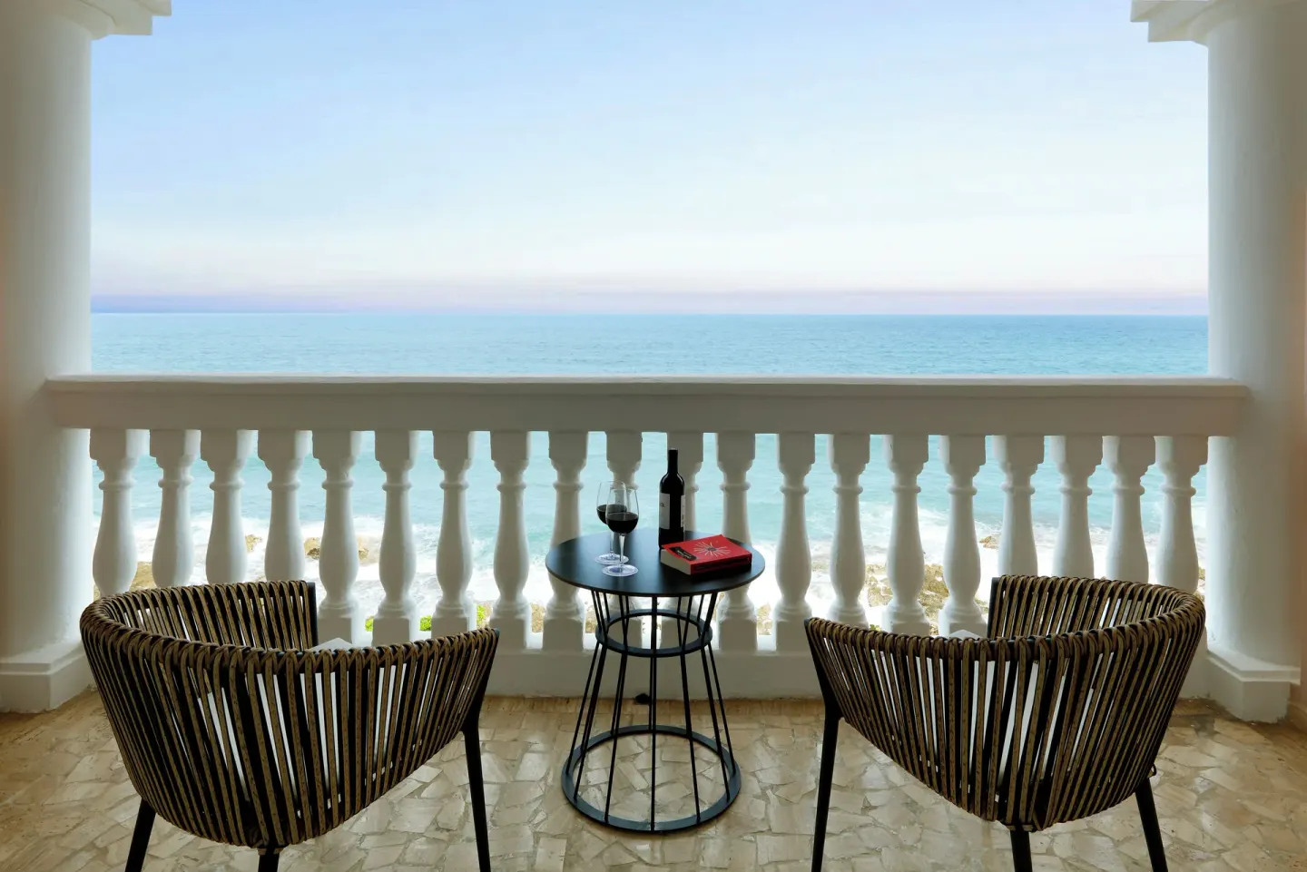 Junior Suite Oceanfront balcony with chairs and sea view at Grand Palladium Jamaica Resort & Spa.