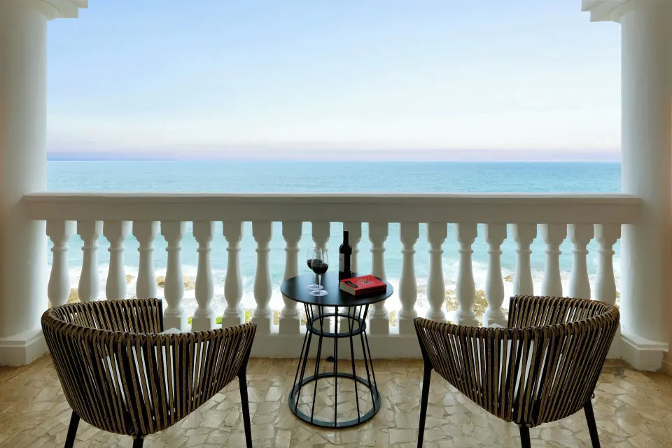 Junior Suite Oceanfront balcony with chairs and sea view at Grand Palladium Jamaica Resort & Spa.