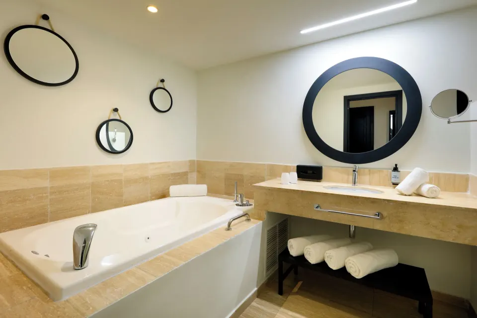 Junior Suite Oceanfront bathroom with tub and vanity at Grand Palladium Jamaica Resort & Spa.
