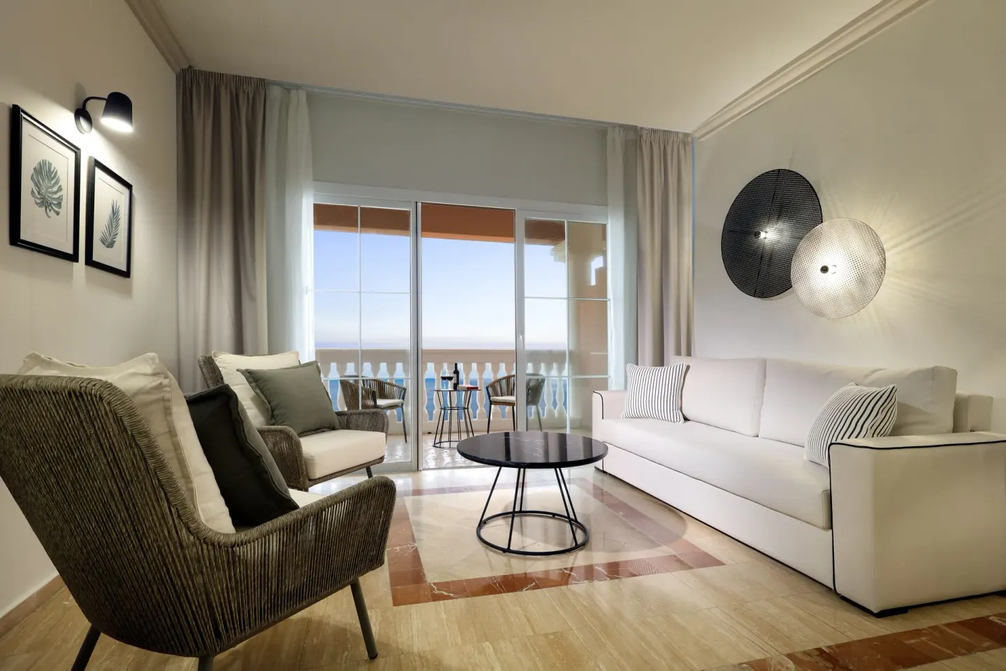 Junior Suite Oceanfront lounge with sofa and balcony at Grand Palladium Jamaica Resort & Spa.