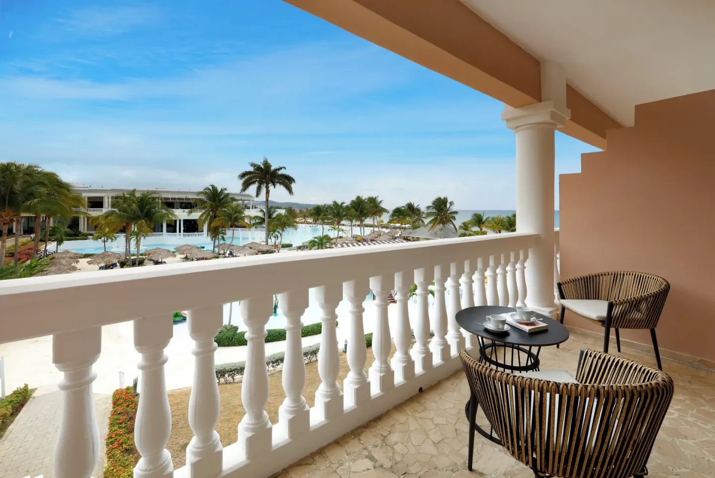 Junior Suite Poolside balcony with chairs at Grand Palladium Jamaica Resort & Spa.