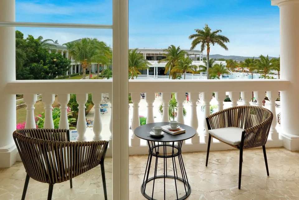 Junior Suite Poolside balcony seating at Grand Palladium Jamaica Resort & Spa.