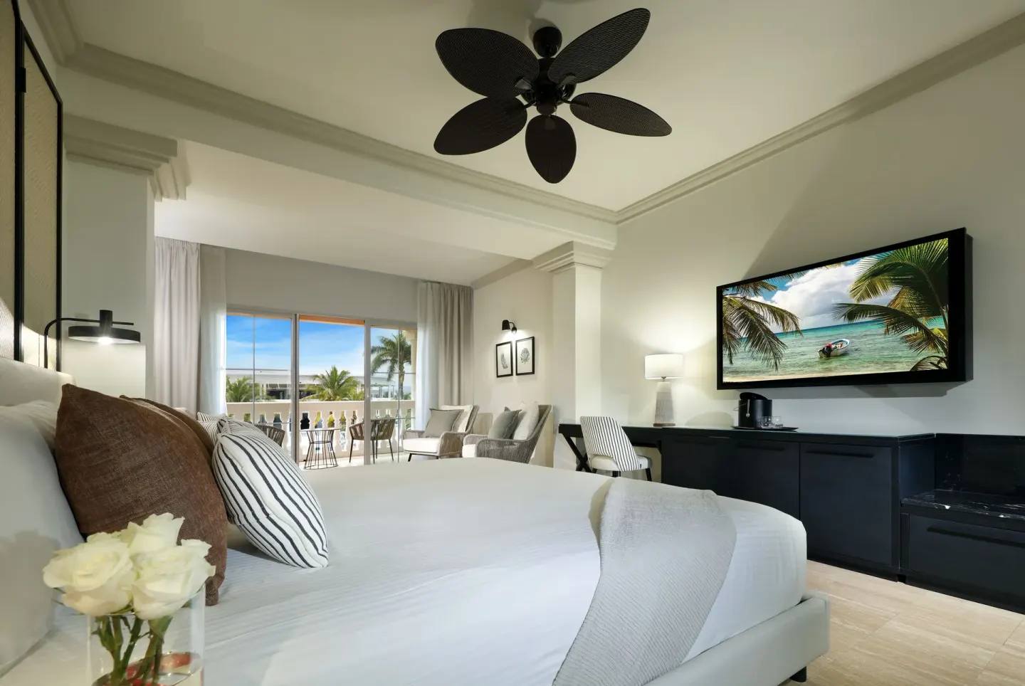 Junior Suite Poolside king bed and balcony at Grand Palladium Jamaica Resort & Spa.