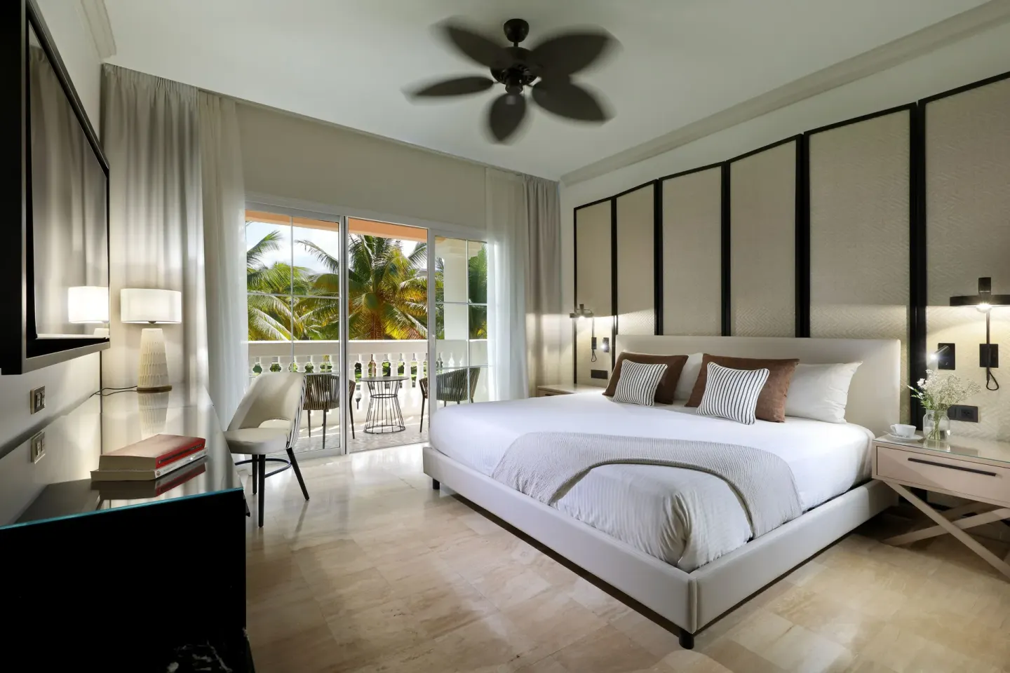 Junior Suite king bed and balcony at Grand Palladium Jamaica Resort & Spa.