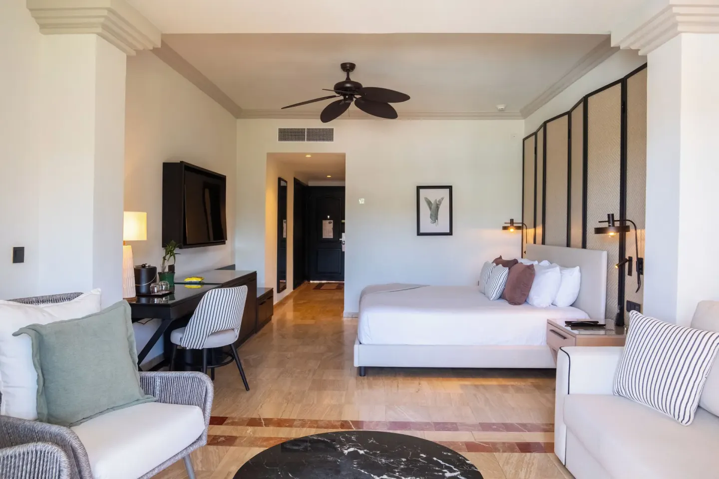 Junior Suite king bed and lounge seating at Grand Palladium Jamaica Resort & Spa.