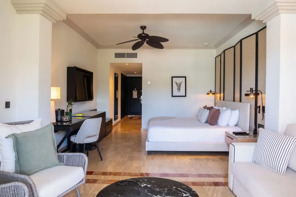 Junior Suite king bed and lounge seating at Grand Palladium Jamaica Resort & Spa.