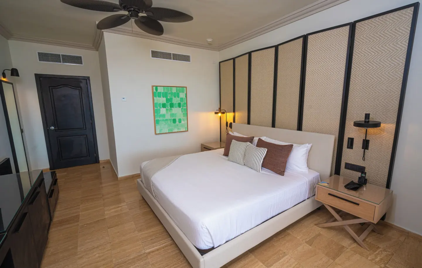 Junior Suite king bed with headboard panels at Grand Palladium Jamaica Resort & Spa.