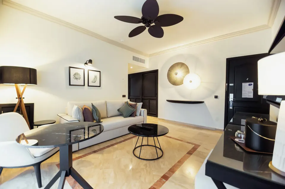 Oceanfront suite living room with sofa and dining table at Grand Palladium Jamaica Resort & Spa.
