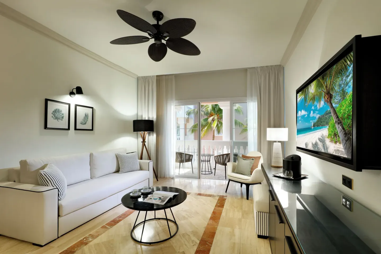 Suite living room with sofa and balcony at Grand Palladium Jamaica Resort & Spa.