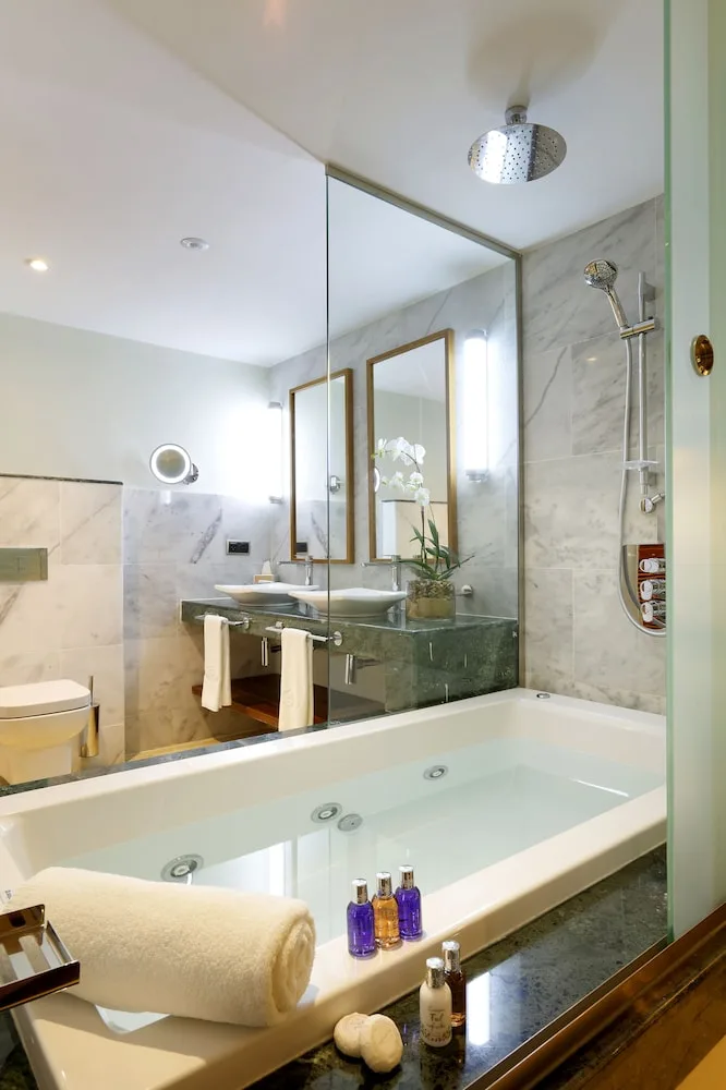 Bathroom soaking tub and vanity at Grand Palladium Palace Resort Spa & Casino.