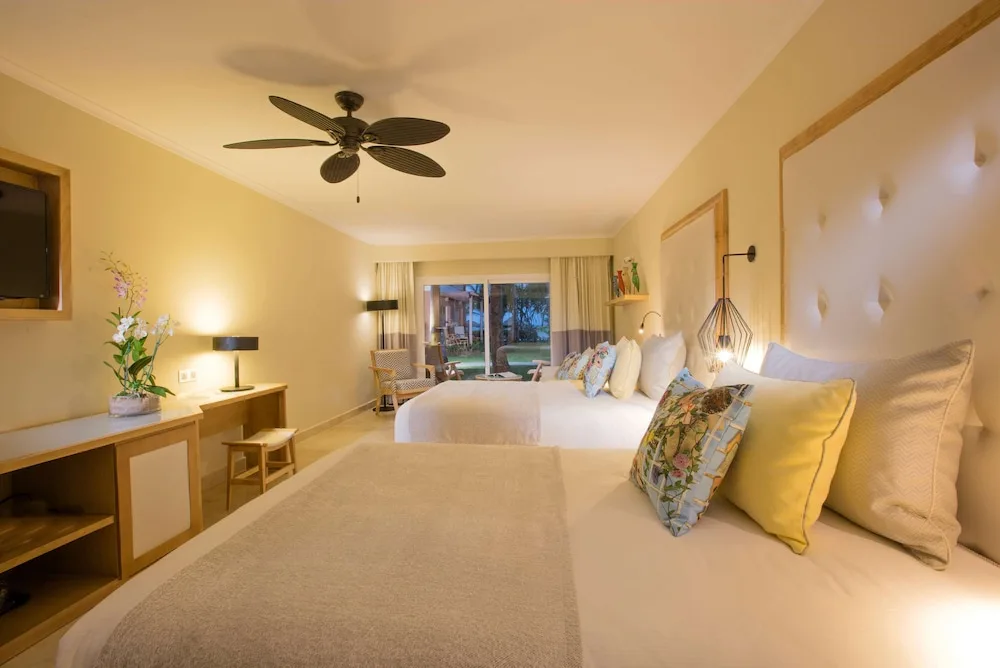Two-bed guest room with patio doors at Grand Palladium Palace Resort Spa & Casino.