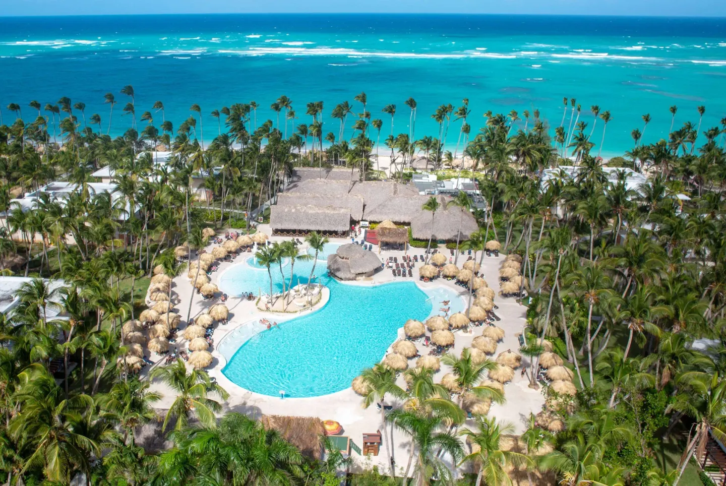 Overhead view of the main pool and beach at Grand Palladium Palace Resort Spa & Casino.