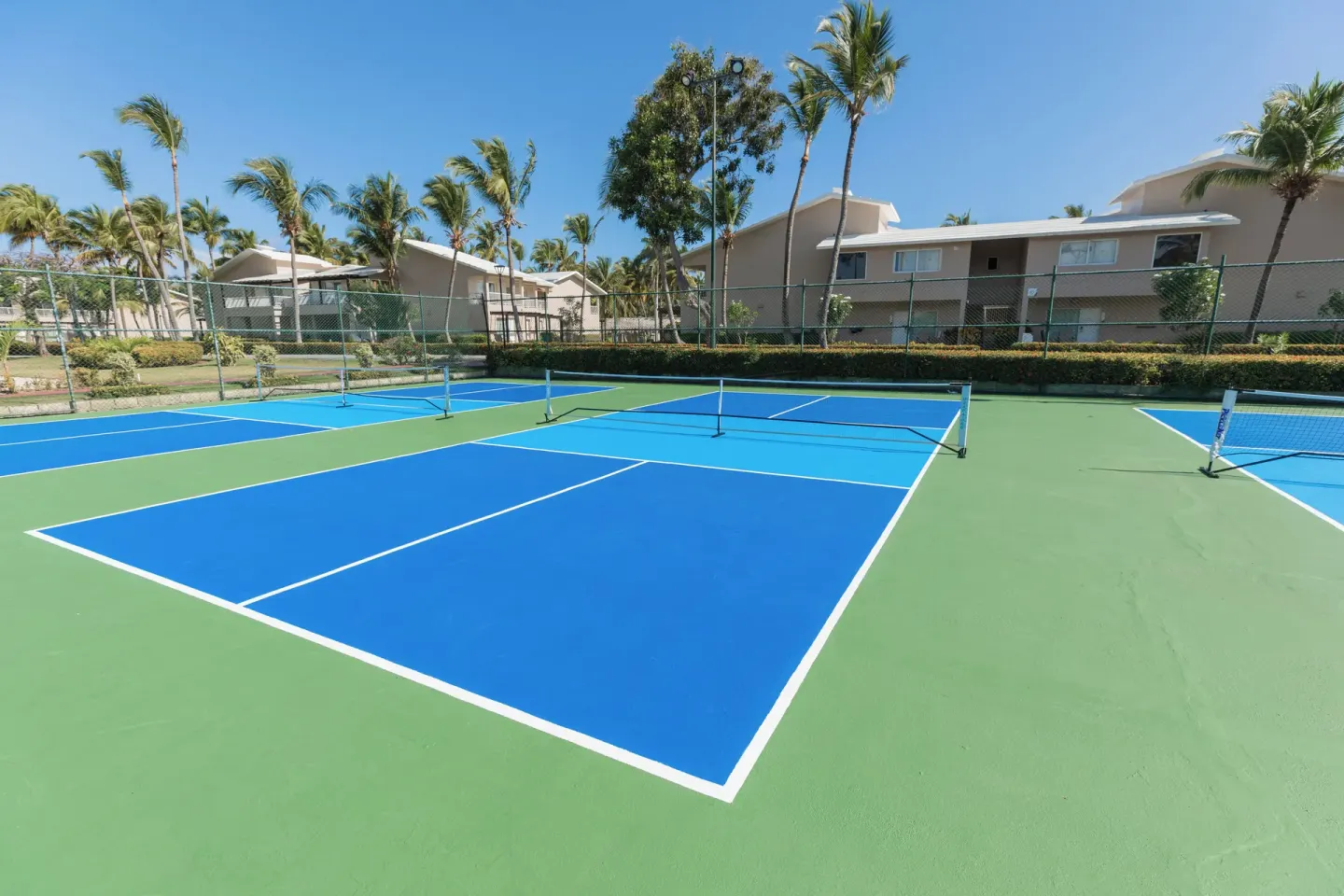 Blue and green pickleball courts at Grand Palladium Palace Resort Spa & Casino.