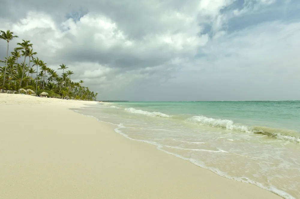 Sandy beach with gentle surf at Grand Palladium Palace Resort Spa & Casino.