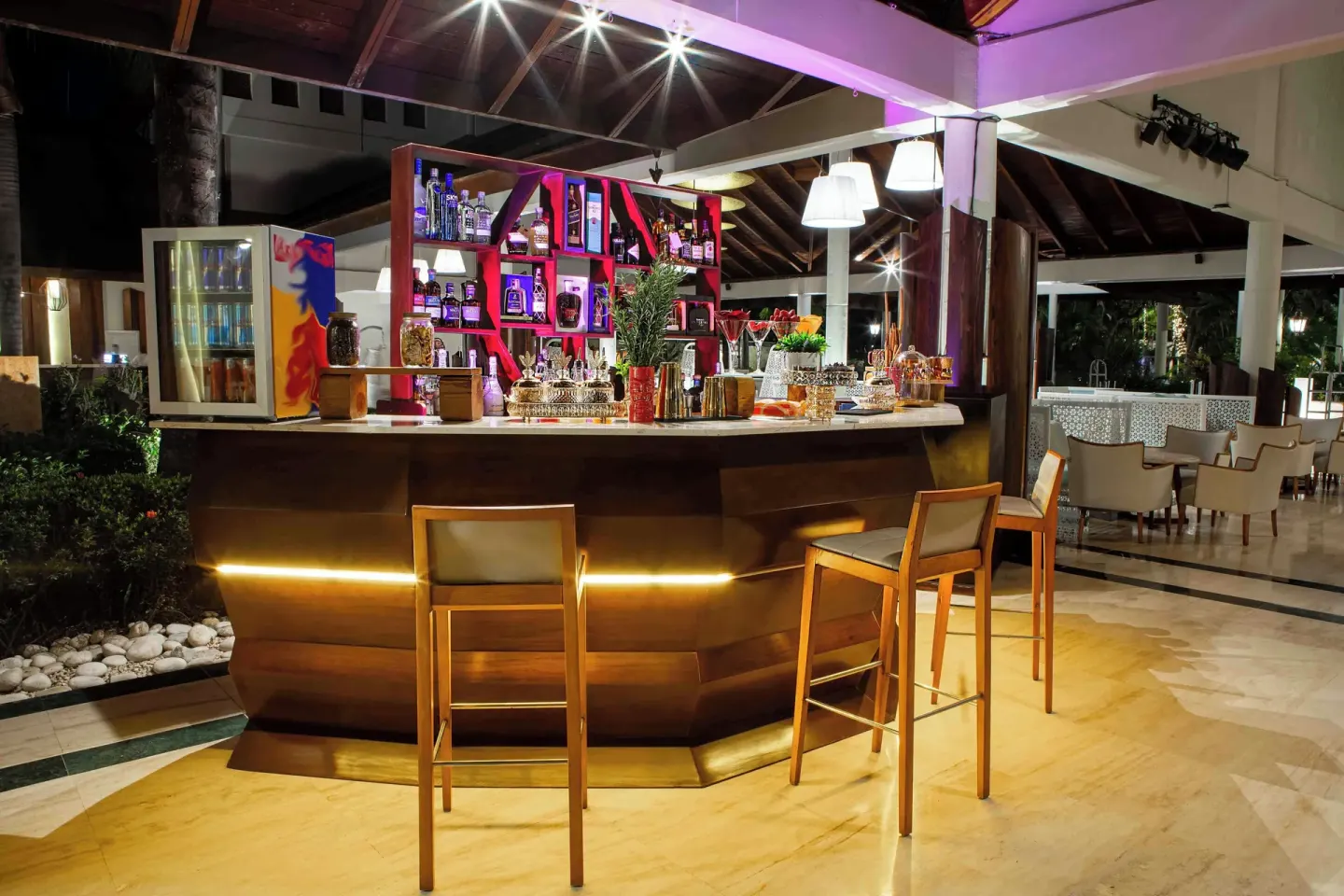 Illuminated open-air bar counter at Grand Palladium Palace Resort Spa & Casino.
