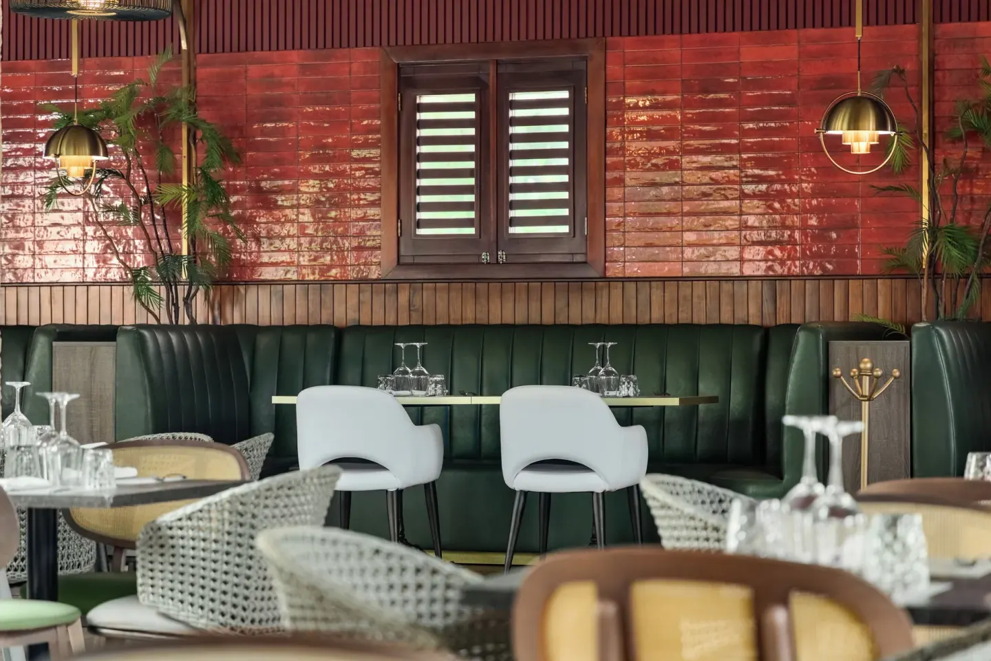 Green banquette seating in a restaurant at Grand Palladium Palace Resort Spa & Casino.
