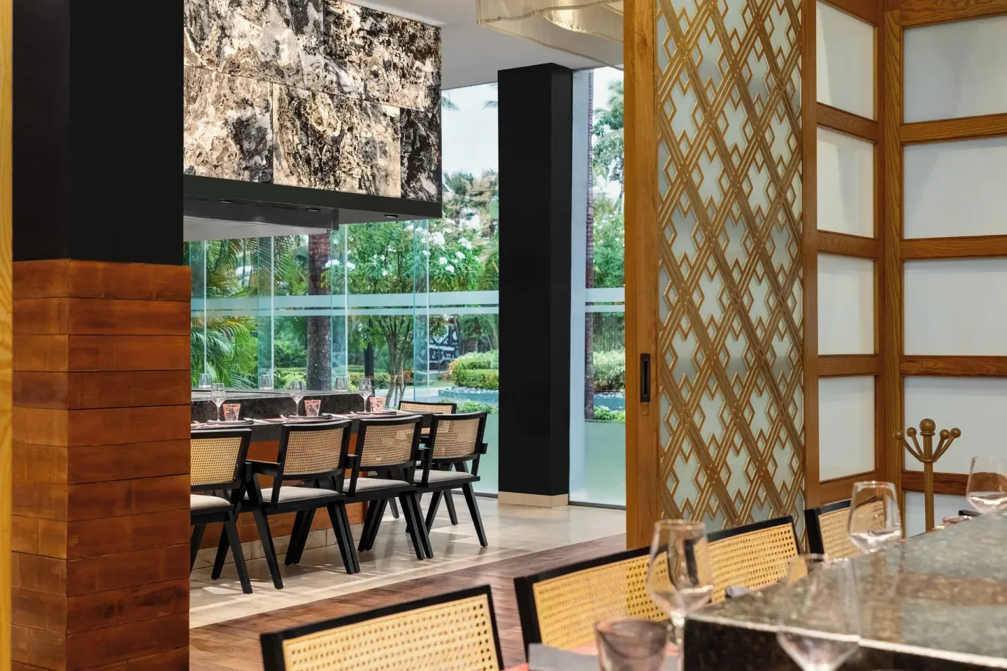 Teppanyaki seating area by garden windows at Grand Palladium Palace Resort Spa & Casino.