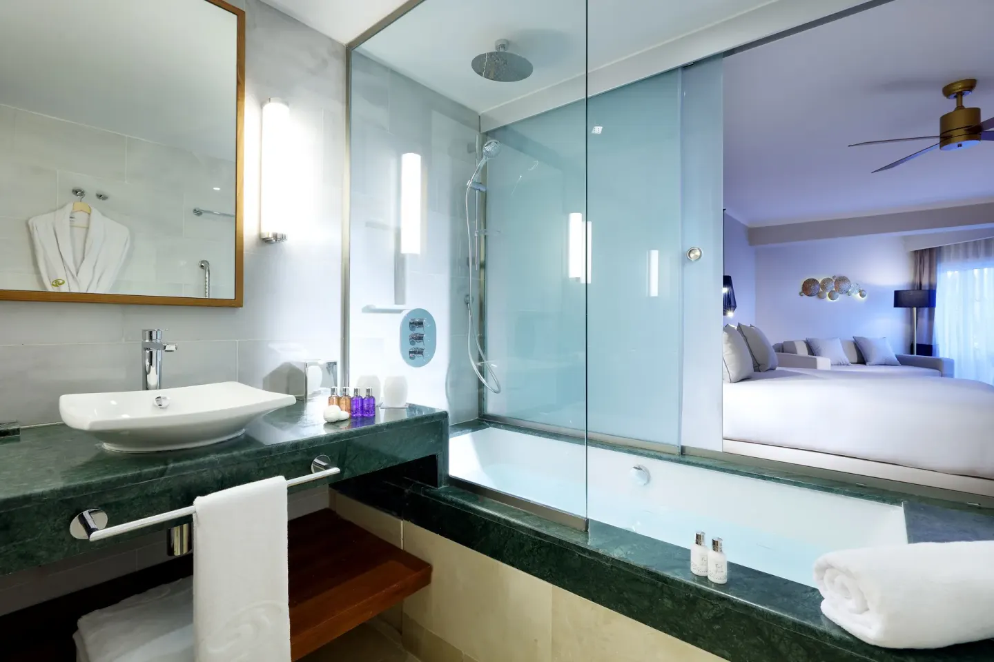 Deluxe Garden View bathroom with tub, shower and vanity at Grand Palladium Palace Resort Spa & Casino.