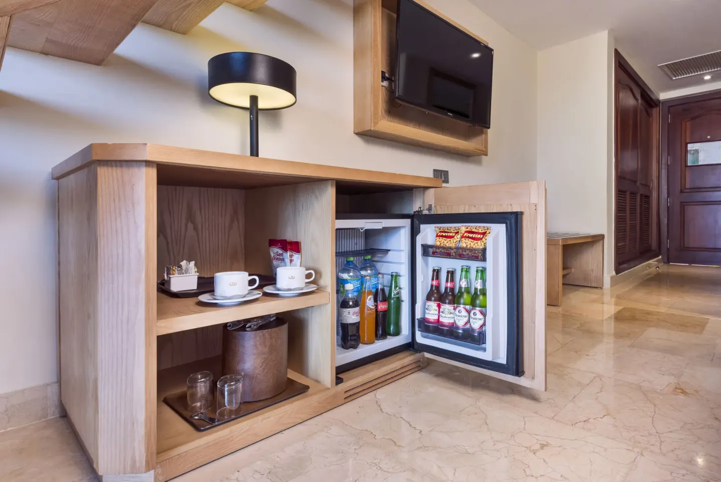 Deluxe Garden View refreshment cabinet and TV at Grand Palladium Palace Resort Spa & Casino.