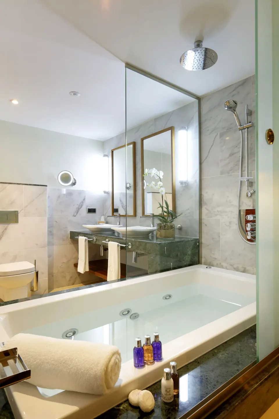 Junior Suite Garden View bathroom with tub and shower at Grand Palladium Palace Resort Spa & Casino.