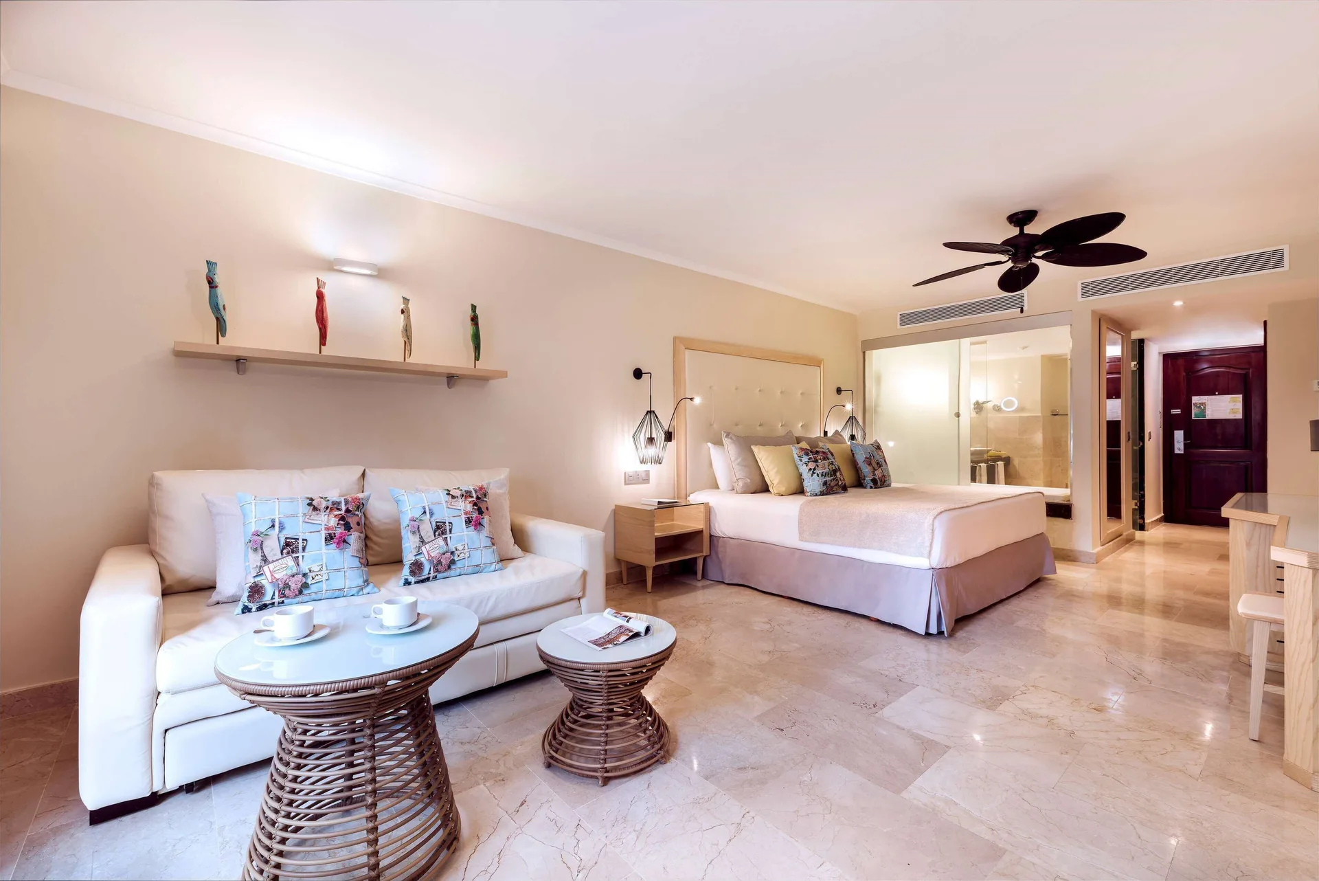 Junior Suite Garden View with king bed and sitting area at Grand Palladium Palace Resort Spa & Casino.