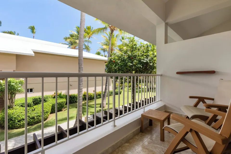 Loft Suite Garden View balcony with chairs at Grand Palladium Palace Resort Spa & Casino.
