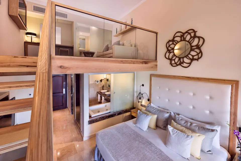 Loft Suite Garden View bedroom and mezzanine at Grand Palladium Palace Resort Spa & Casino.