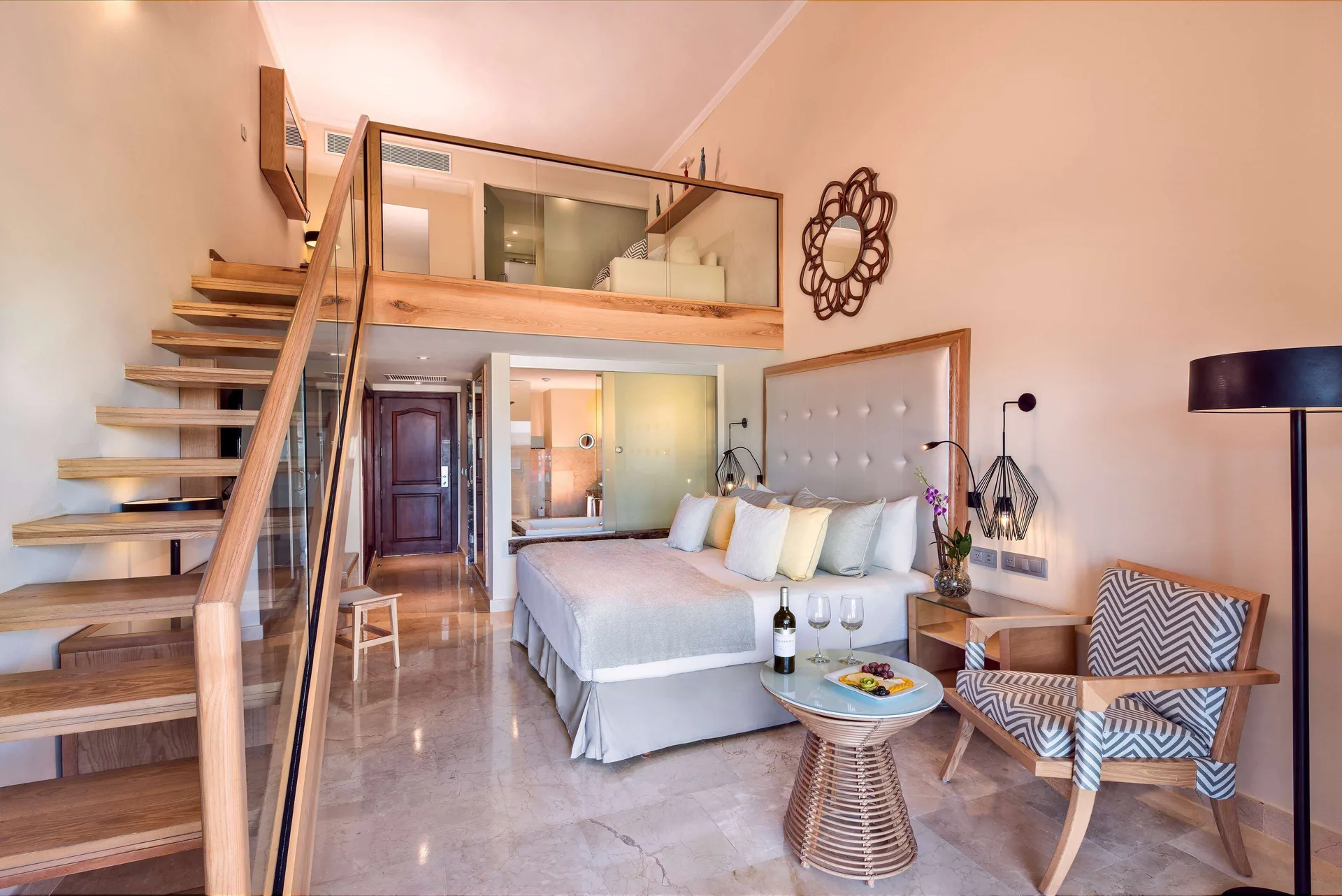 Loft Suite Garden View with king bed and staircase at Grand Palladium Palace Resort Spa & Casino.