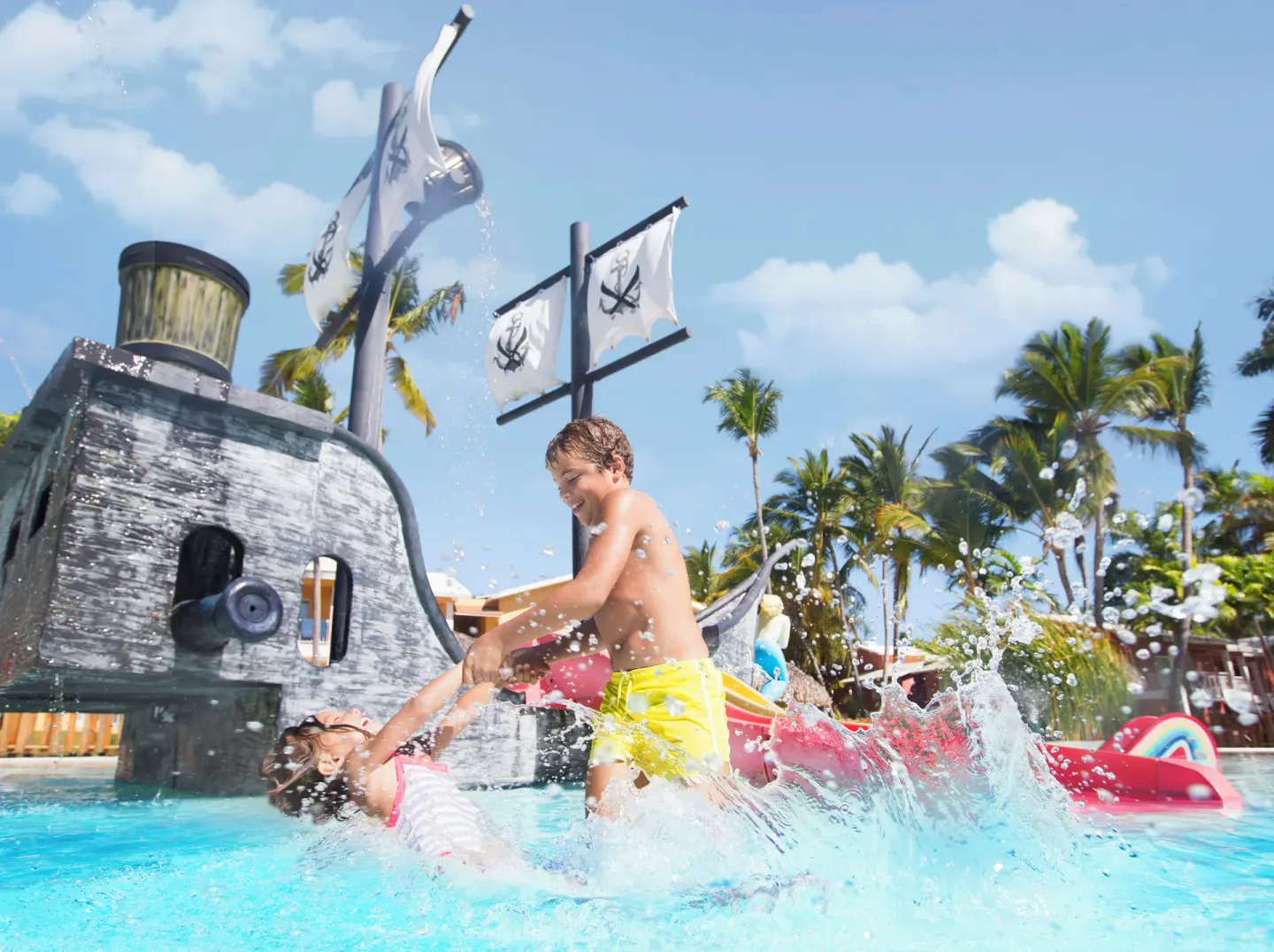 Children splashing by a pirate ship pool at Grand Palladium Punta Cana Resort & Spa.