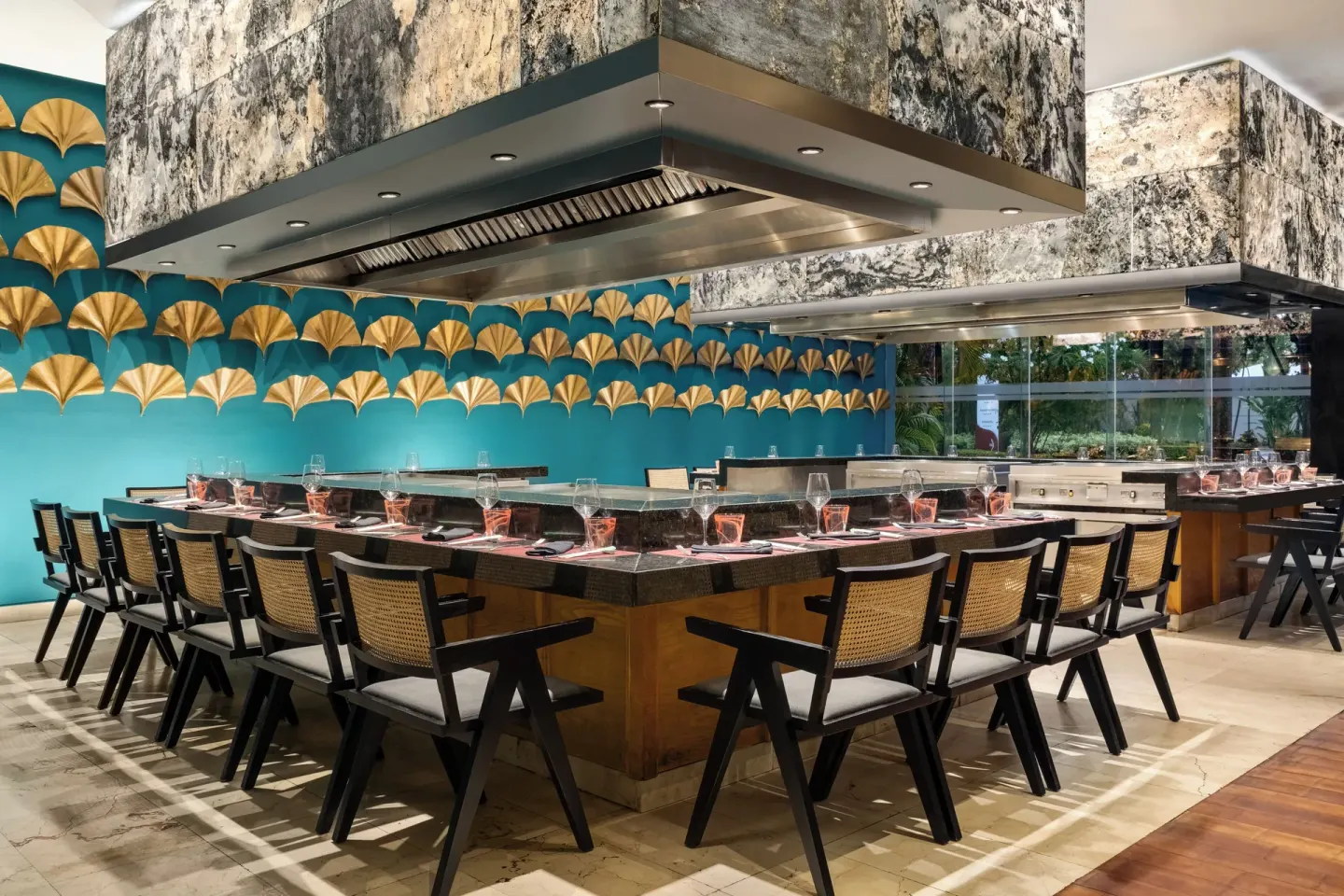 Teppanyaki-style dining counter with turquoise wall décor at Grand Palladium Punta Cana Resort & Spa.