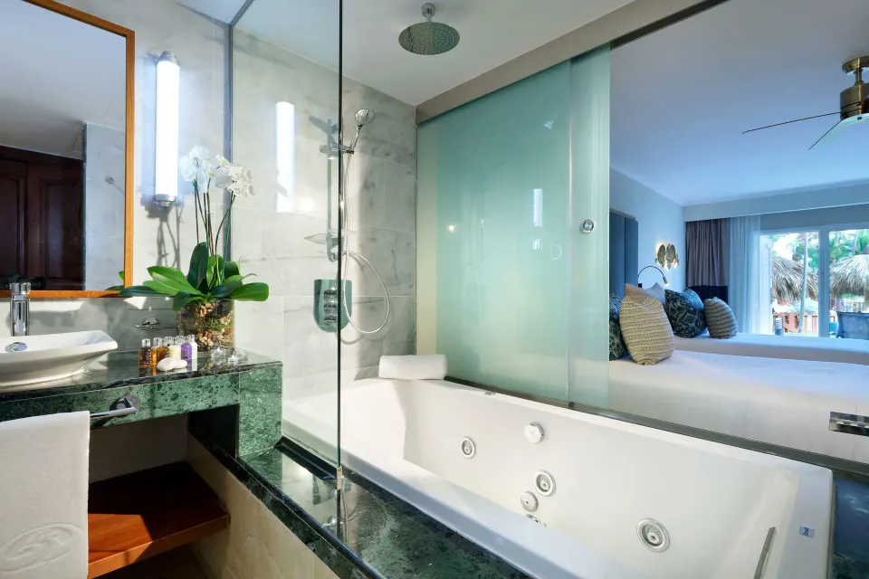 Deluxe Garden View bathroom with tub and shower at Grand Palladium Punta Cana Resort & Spa.
