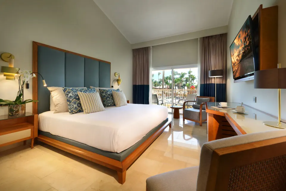Deluxe Garden View king room with balcony doors at Grand Palladium Punta Cana Resort & Spa.